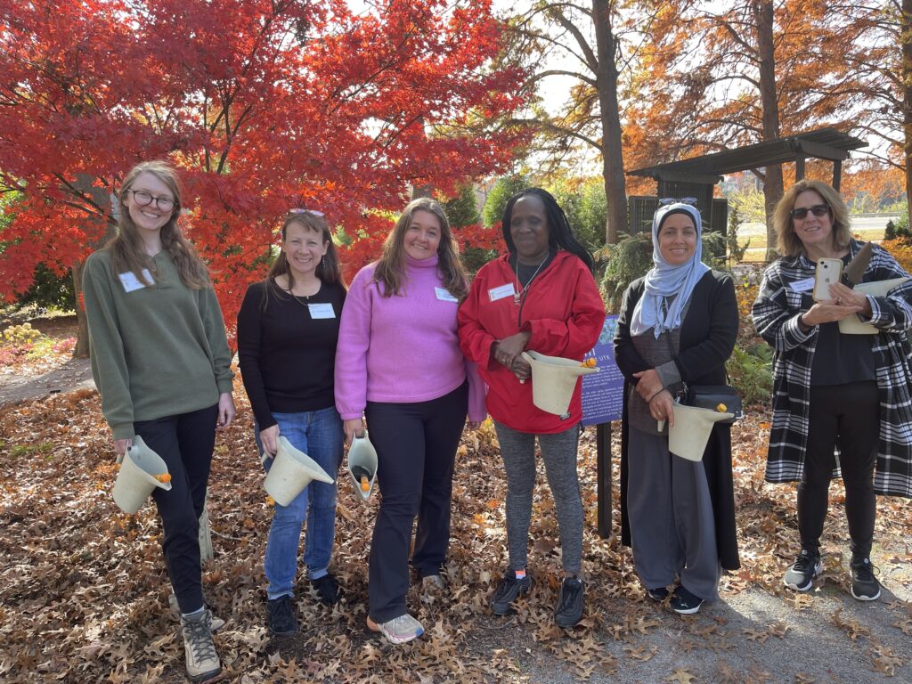 Image of women in front of a tree with red leaves