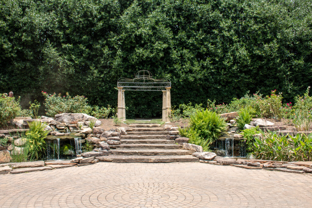 arbor flanked by 2 waterfall ponds