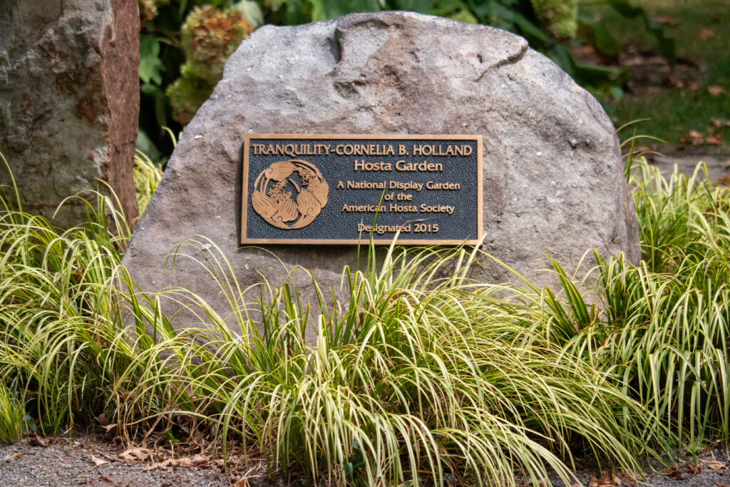 Plaque that reads " Tranquility- Cornelia B. Holland Hosta Garden A National Display Garden of the American Hosta Society Designated in 2015"